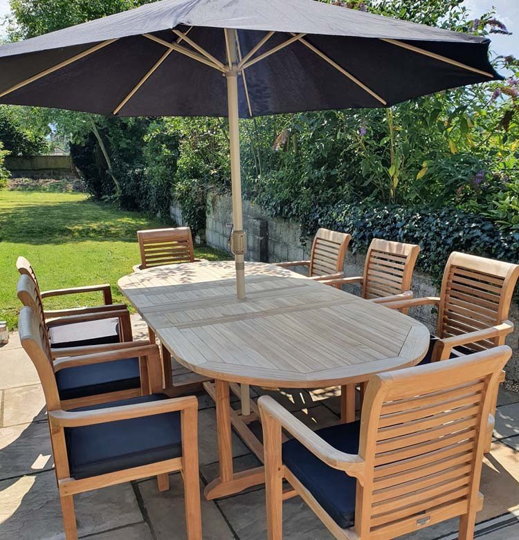 This teak garden dining set is amazing value - double extending table 1.8m to 2.4m, 8 x teak stacking chairs, free 3m parasol and cushions